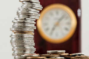 british sterling coins stacked high on a desk. Convertibill Blog